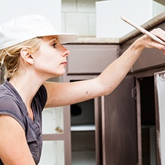 woman painting cabinets