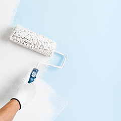 a paint roller painting a wall