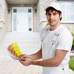 Painter holding up color shade samples