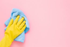 hand holding a towel to dry after the dirty walls were cleaned