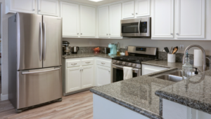 a painted kitchen with several stainless steel appliances 
